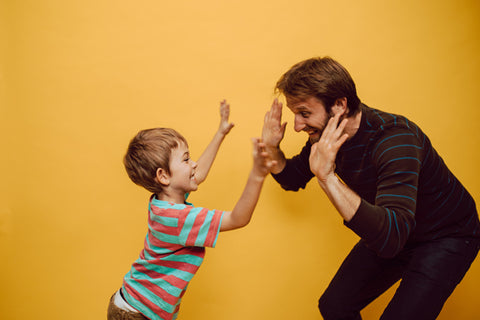 dad and son highfiving, DEI resources for parents