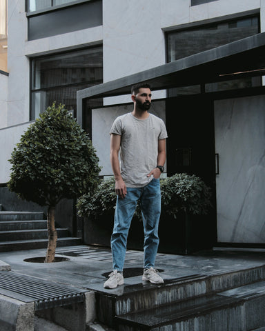 Man in a properly fitting shirt and jeans.