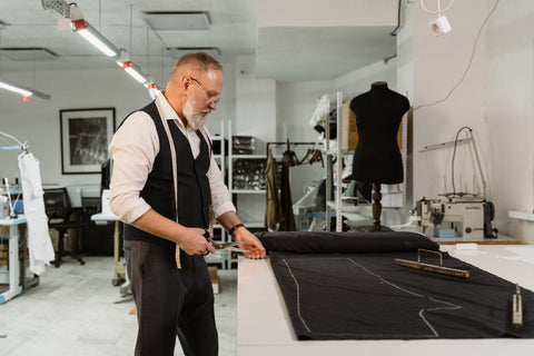 Tailor making a custom suit