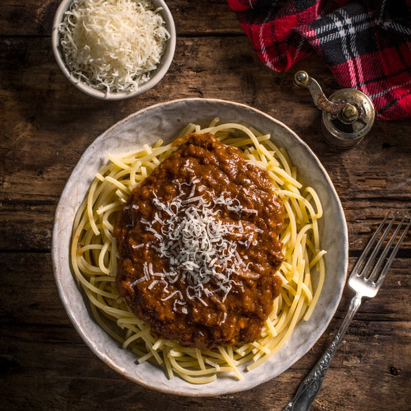 Beef Bolognese on a dish with parmesan cheese