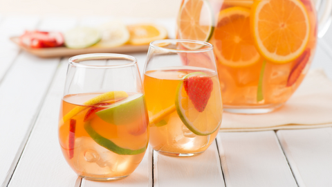 Beautiful food photography: clear pitcher and two round glasses of sangria. Recipe made using Tetley Pomegranate Green tea. 