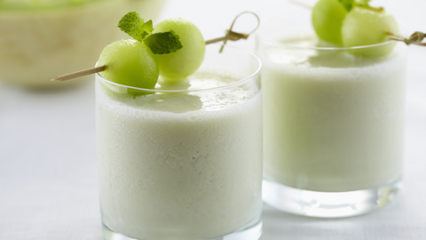 Beautiful food photography: two small round glasses filled with the smoothie. Recipe made using Tetley Pure Green tea