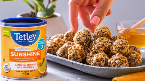 Beautiful food photography: a tray of bitesized energy balls packed with Vitamin D and perfect for snacking. Recipe made using Tetley Super Herbal Sunshine tea. 