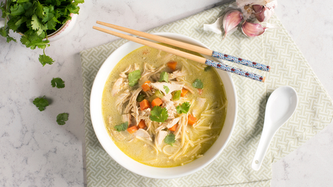 Beautiful food photography: a comforting bowl of classic chicken noddle soup infused with Thai flavours. Recipe made using Tetley Care tea. 