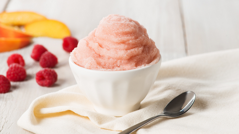 Beautiful food photography: a small bowl filled with the intense peach flavour of Bellini sorbet. Recipe made using Tetley Bellini tea. 