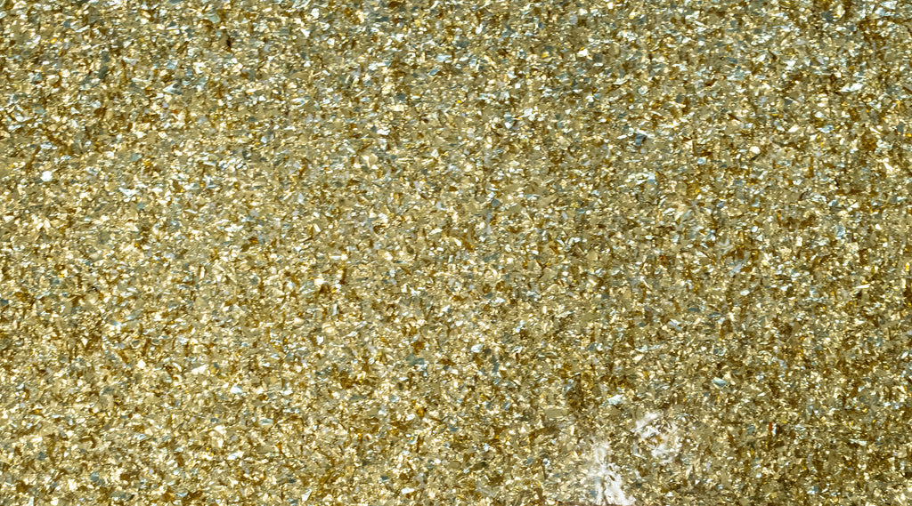 A shiny gold glitter epoxy resin flooring slab.