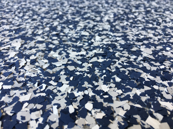 Blue and white vinyl flakes designed for an epoxy resin garage flooring installation.