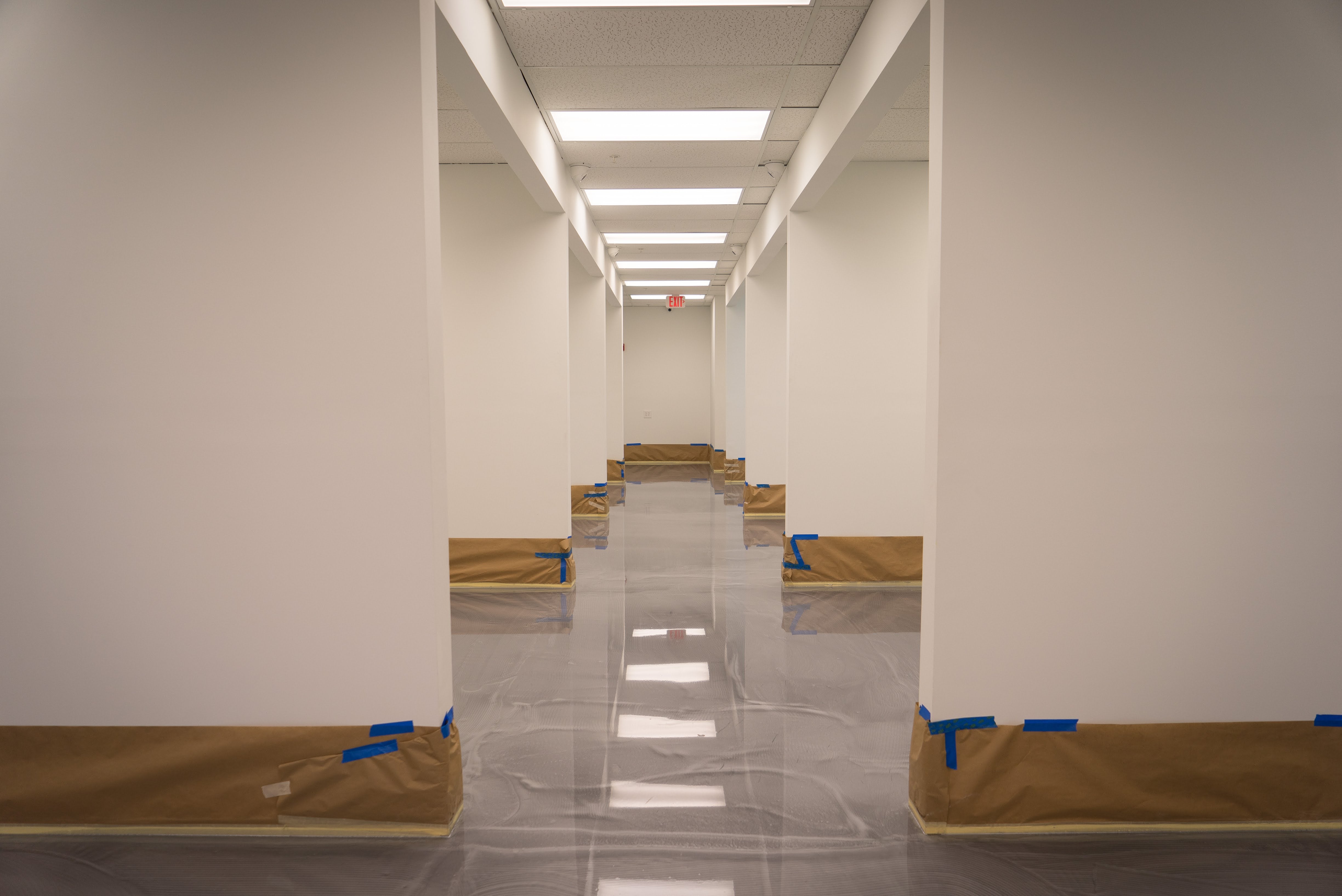 A hallway inside a commercial establishment with metallic epoxy floors | Xtreme Polishing Systems