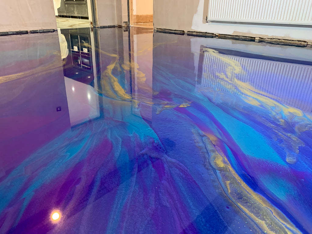 A metallic epoxy resin styled flooring system installed on a concrete foundation.