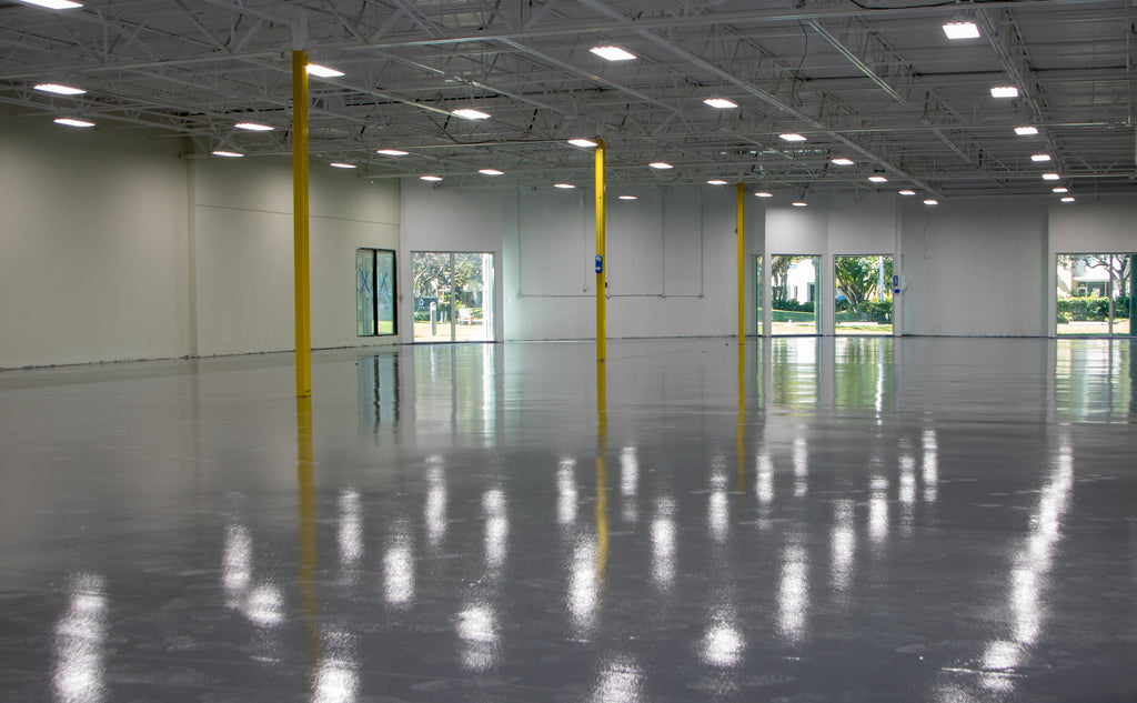 Epoxy resin grind and seal installation in a large industrial warehouse flooring space.