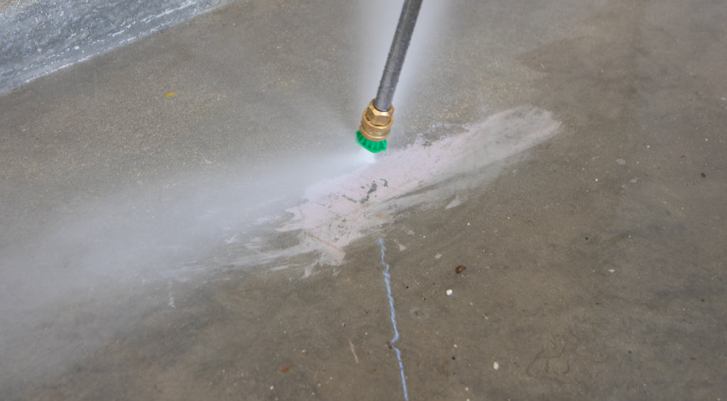 Pressure washer cleaning oil & grime from a concrete floor to prepare for an epoxy resin installation.