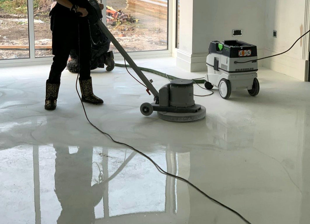 An installer performing epoxy floor maintenance with a buffing machine | Xtreme Polishing Systems