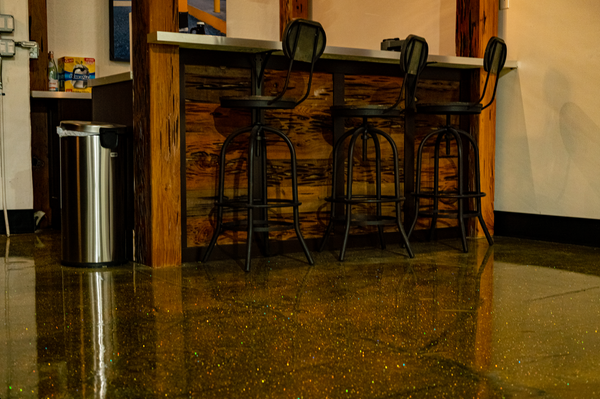 A gold glitter epoxy floor inside a cigar lounge.