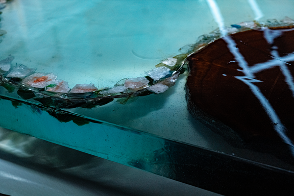 An epoxy river table with decorative stones embedded into it.