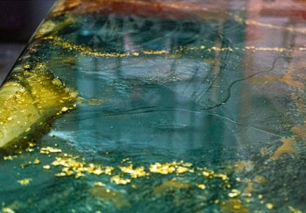 A turquoise and gold metallic epoxy countertop.