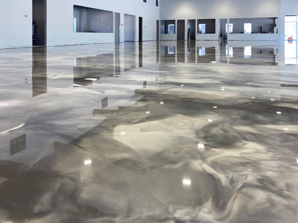 A metallic epoxy floor inside a large commercial space.