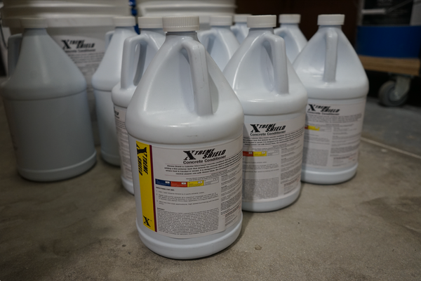 An image of various Xtreme Shield Concrete Sealer bottles inside a warehouse.