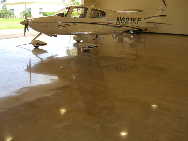 A polished concrete floor inside a residential airplane hangar.