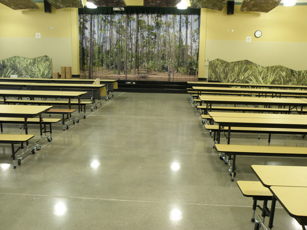 A polished concrete floor inside a school cafeteria.
