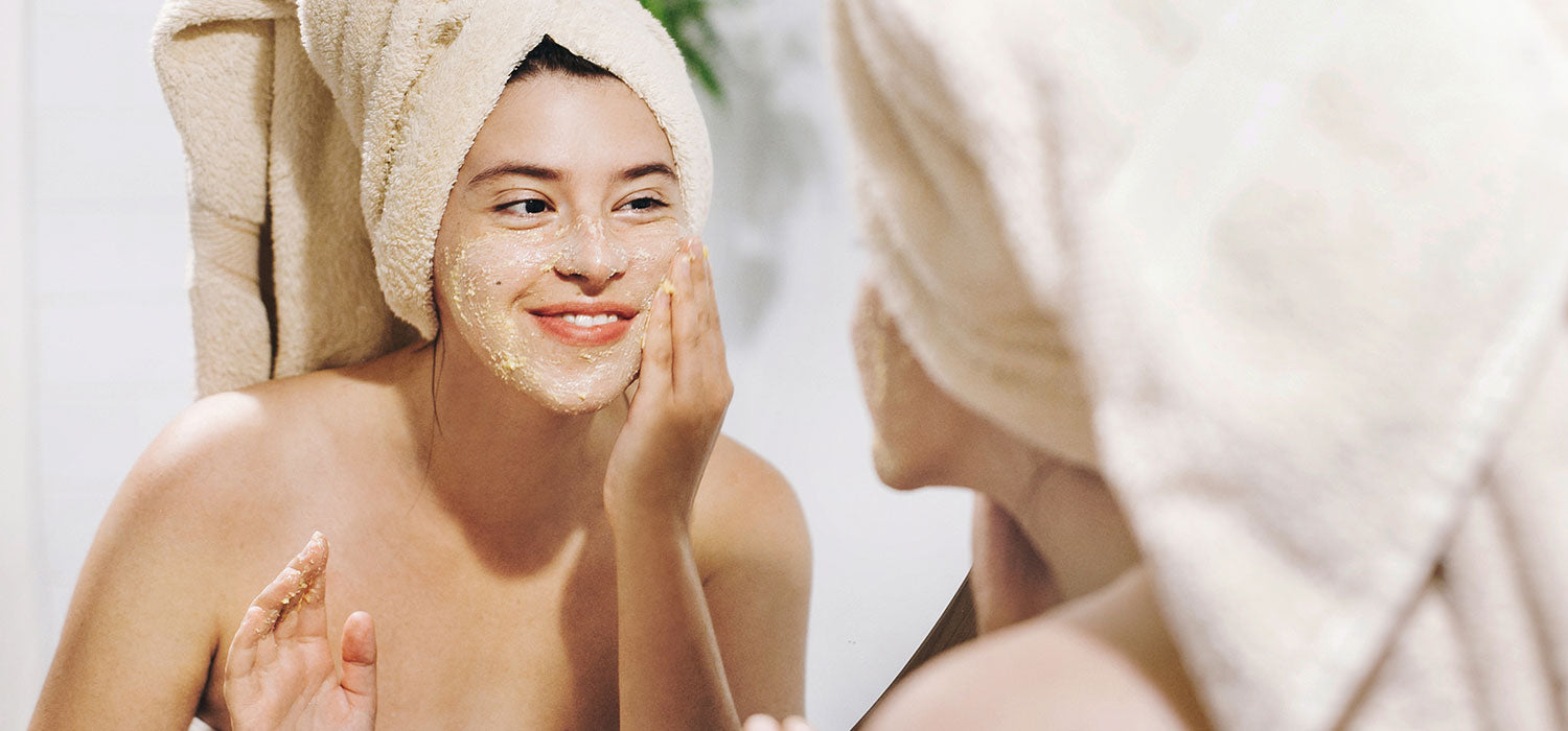 A joyful woman applying a facial mask, her face radiating happiness and satisfaction as she indulges in this pampering and rejuvenating skincare ritual.