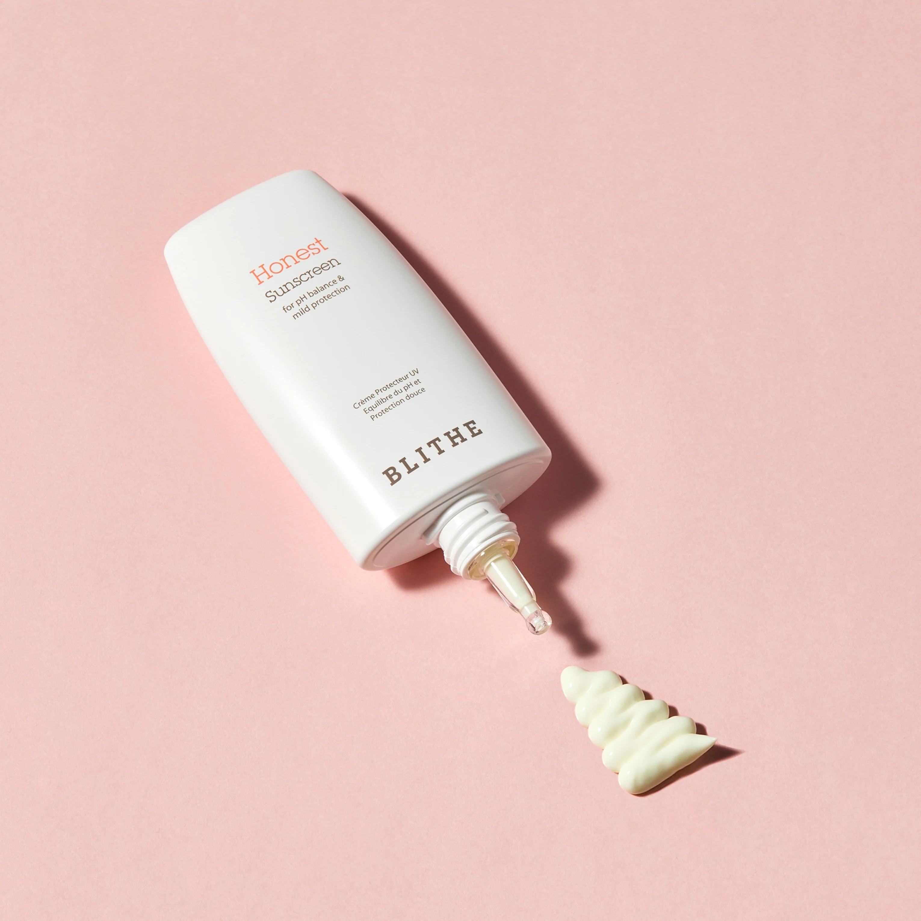 Blithe Cosmetics’ Honest Sunscreen on a pink background