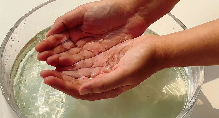 Hands gently cupping a bowl of Blithe Patting Splash Mask with Soothing and Healing Green Tea, showcasing the nurturing and revitalizing essence of the product for winter skincare.