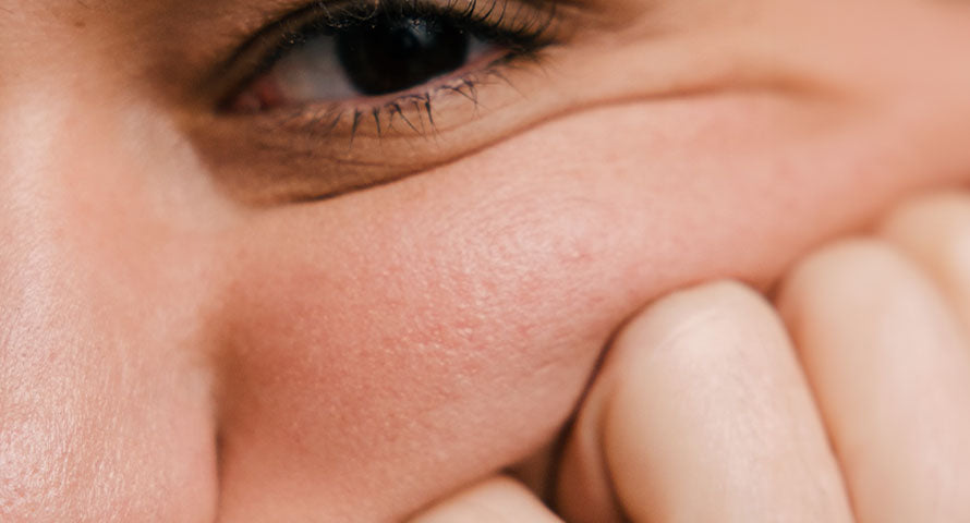 Close-up of a woman's face, showcasing clear, radiant skin with a soft, natural glow, symbolizing healthy skincare practices.