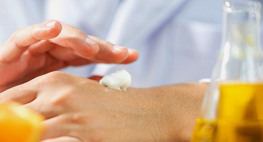 Woman applying moisturizing cream to her hand, nourishing and hydrating the skin.