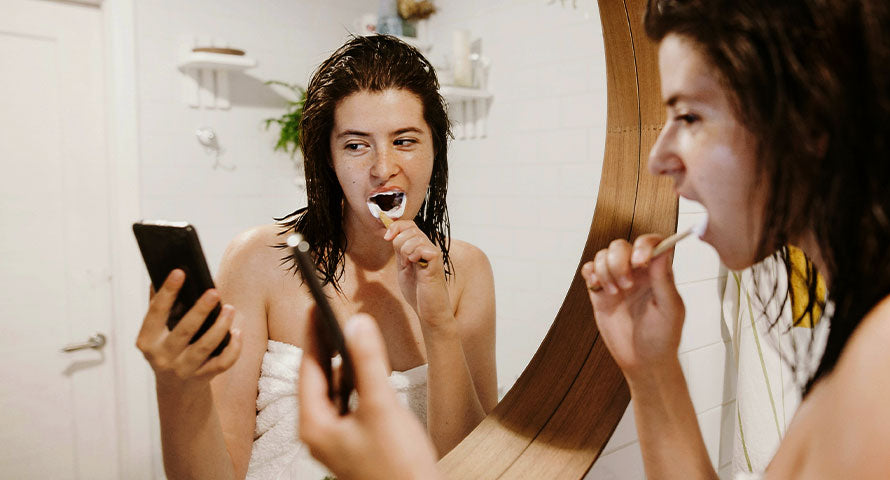 Girl using a tooth whitening product, capturing a personal care routine aimed at achieving a brighter, more confident smile.
