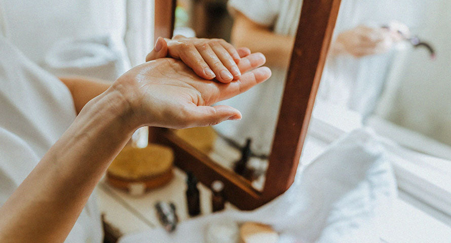 Close-up image of a woman's hand and arm, elegantly displaying her smooth, well-cared-for skin as a testament to effective skincare practices.