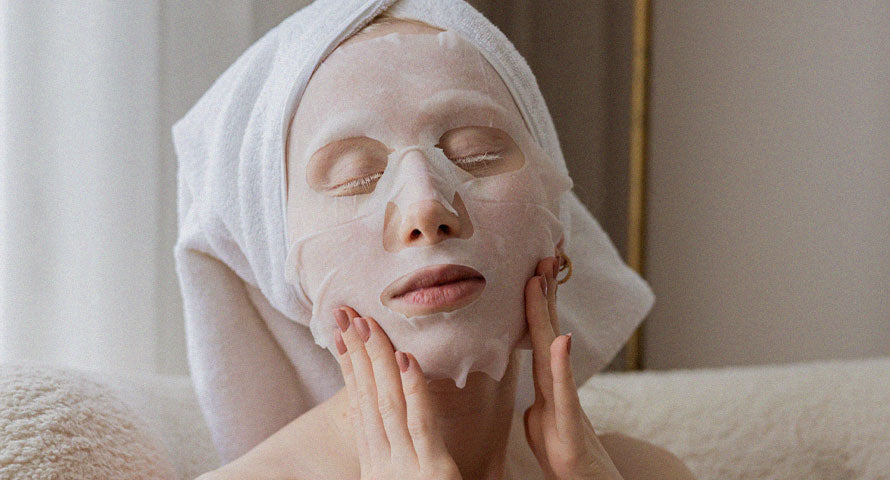 Woman relaxing with a nourishing facial mask applied, enjoying her self-care skincare routine