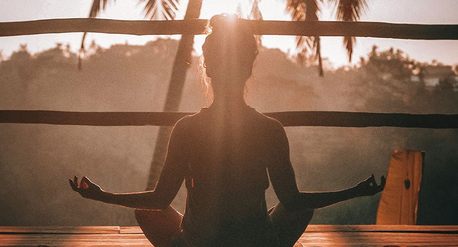 Woman practicing yoga, embodying tranquility and balance in a peaceful setting