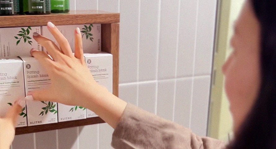 Image of a shelf neatly stacked with Blithe Patting Splash Mask Soothing and Healing Green Tea products, showcasing their distinctive packaging and branding.