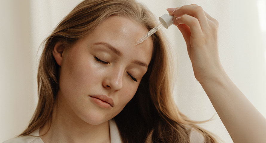 Woman delicately applying facial serum, embodying a vital part of her skincare routine to nourish and rejuvenate her complexion.