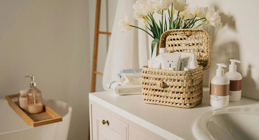 A minimalist bathroom shelf with a curated selection of beauty products, including sleek bottles and jars, against a clean, white background.