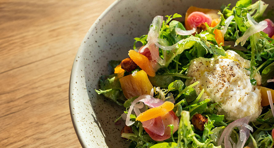 Bowl of fresh salad filled with a variety of colorful vegetables, illustrating a healthy meal option.