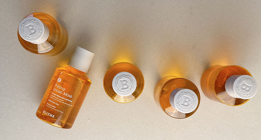 Image of several bottles of Blithe Patting Splash Mask in Energy Yellow Citrus and Honey variant, arranged neatly.