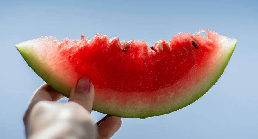 Close-up of a juicy slice of watermelon, a refreshing summer treat, on a sunny day.