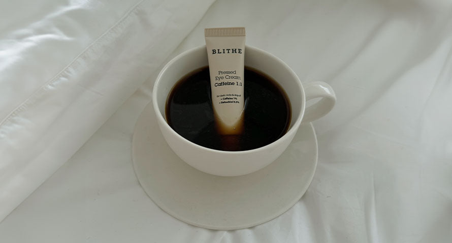 Blithe Eye Cream creatively presented in a coffee cup, symbolizing the infusion of caffeine, one of its key ingredients, into the skincare product.