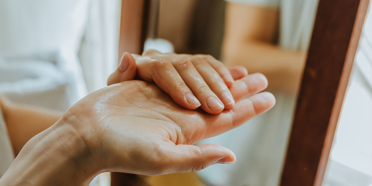 A detailed image capturing the delicate grace of a woman's hands, their gentle pose and refined touch reflecting care and elegance.