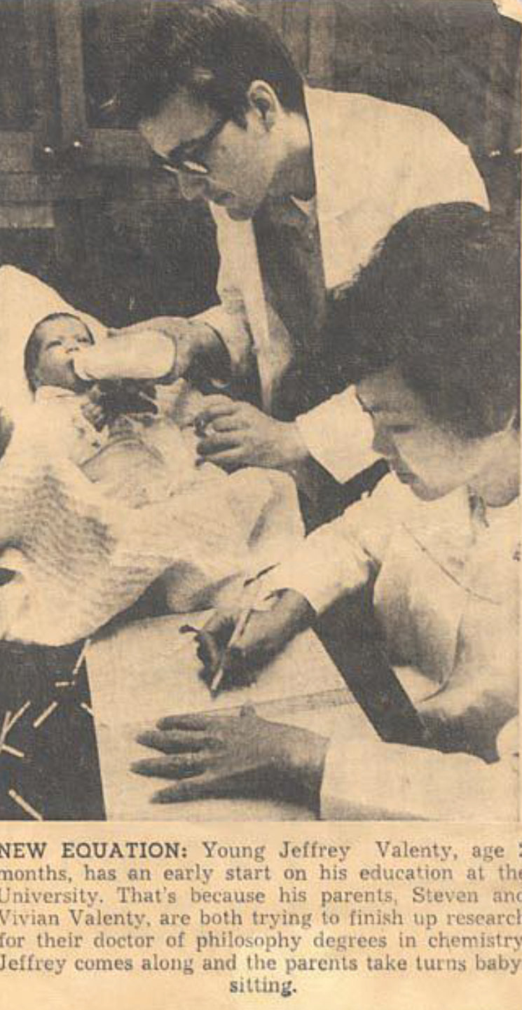 Young mother, Dr. Vivian Valenty signs paperwork with a baby on the desk