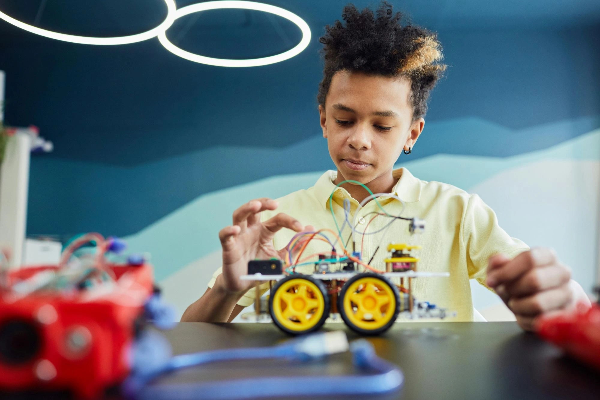 A boy working on a STEM car project
