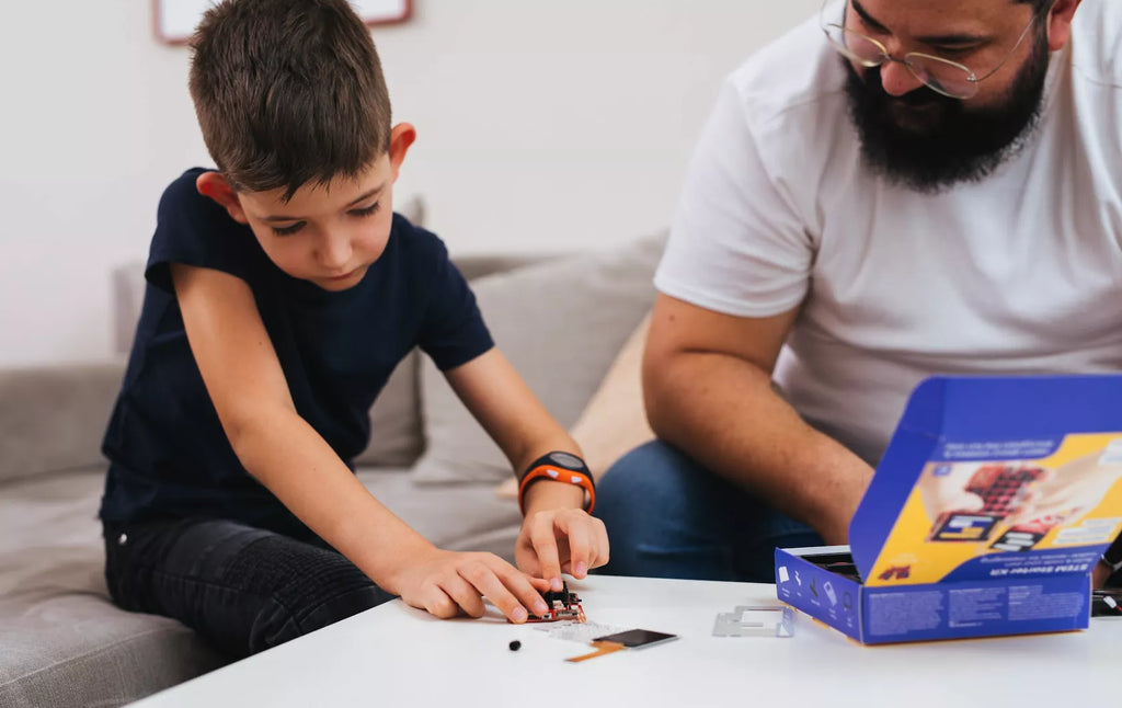 Parent and kid building their Chatter electronics kit from CircuitMess