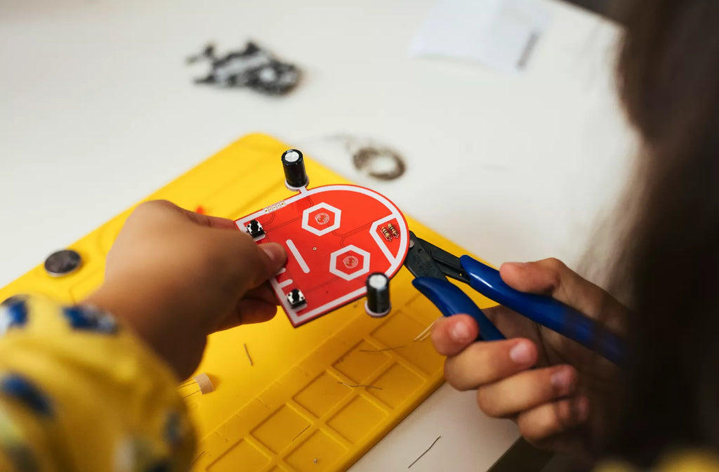 Kid playing with CircuitMess Wacky Robots