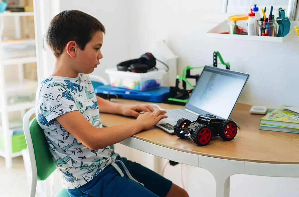 Kid coding his CircuitMess Wheelson STEM toy