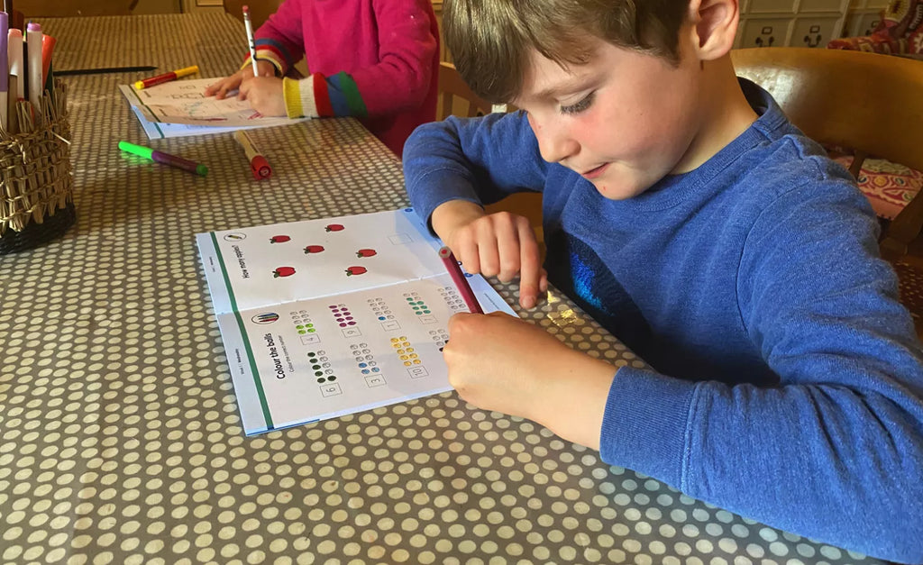 8-year-old kids playing with Cubie Education subscription box