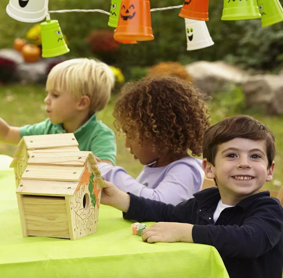 kids playing with their DIY birdhouse