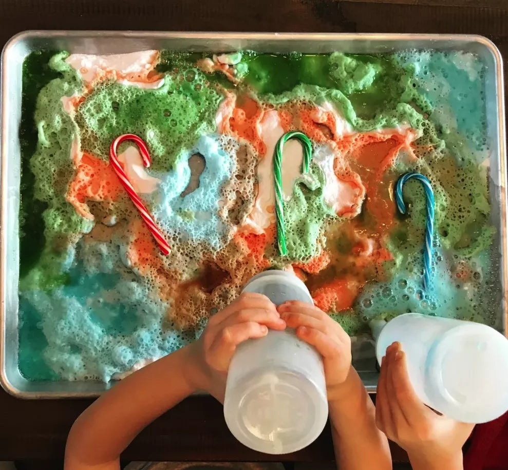 Kids making fizzy candy canes as a Christmas science experiment