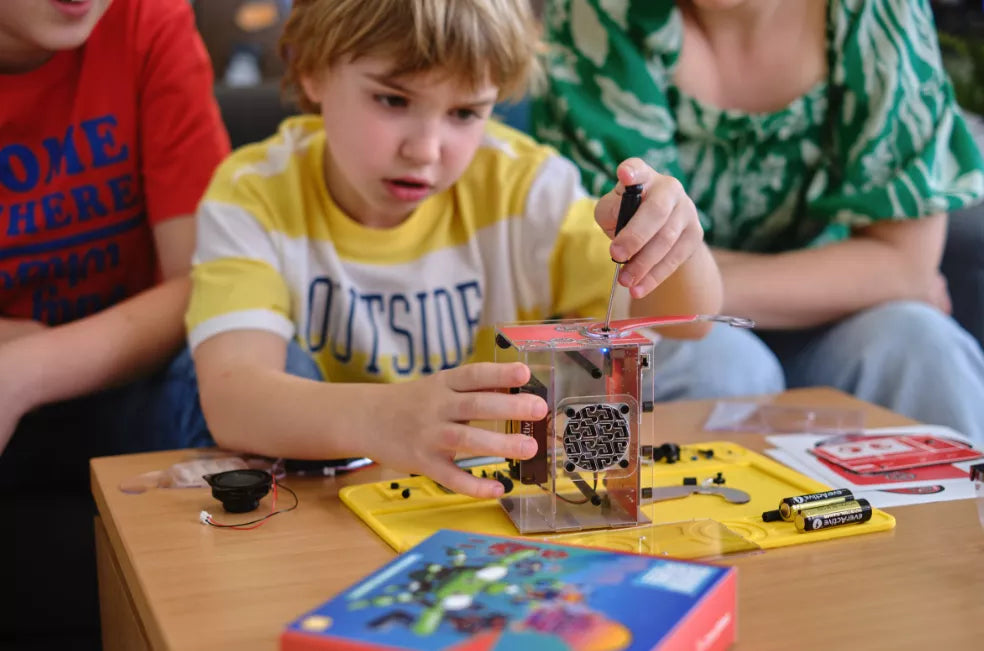 Kid assembling a DIY bluetooth speaker