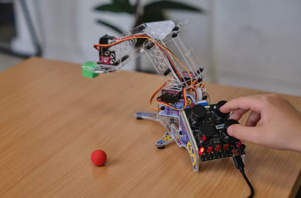 Kid playing with a DIY robotic arm